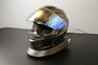 Smart Helmet and Gear Dryer Pro beneath a reflective motorcycle helmet on a neutral background
