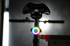Bicycle rear view with a multicolor halo light glowing beneath the saddle