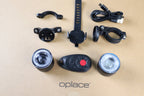 RGB halo bike light set with two round lights, wireless remote, mounts and cables arranged together