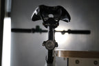 Rear bicycle view with an unlit round light mounted below the saddle