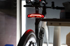 OPlace alarm tail light mounted below a saddle beside a rear rack