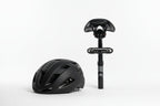 Bike helmet beside a seatpost-mounted OPlace alarm tail light on white
